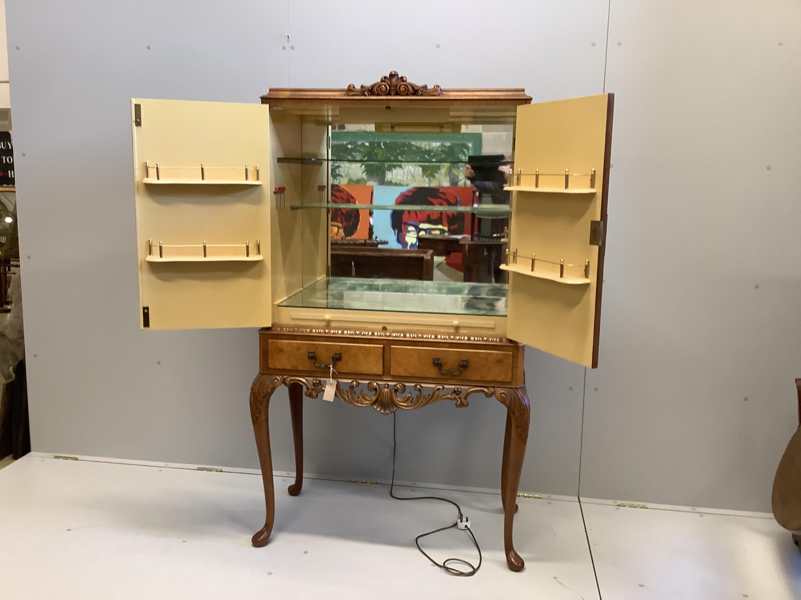 A mid 20th century Queen Anne revival walnut cocktail cabinet, width 94cm, depth 45cm, height 160cm